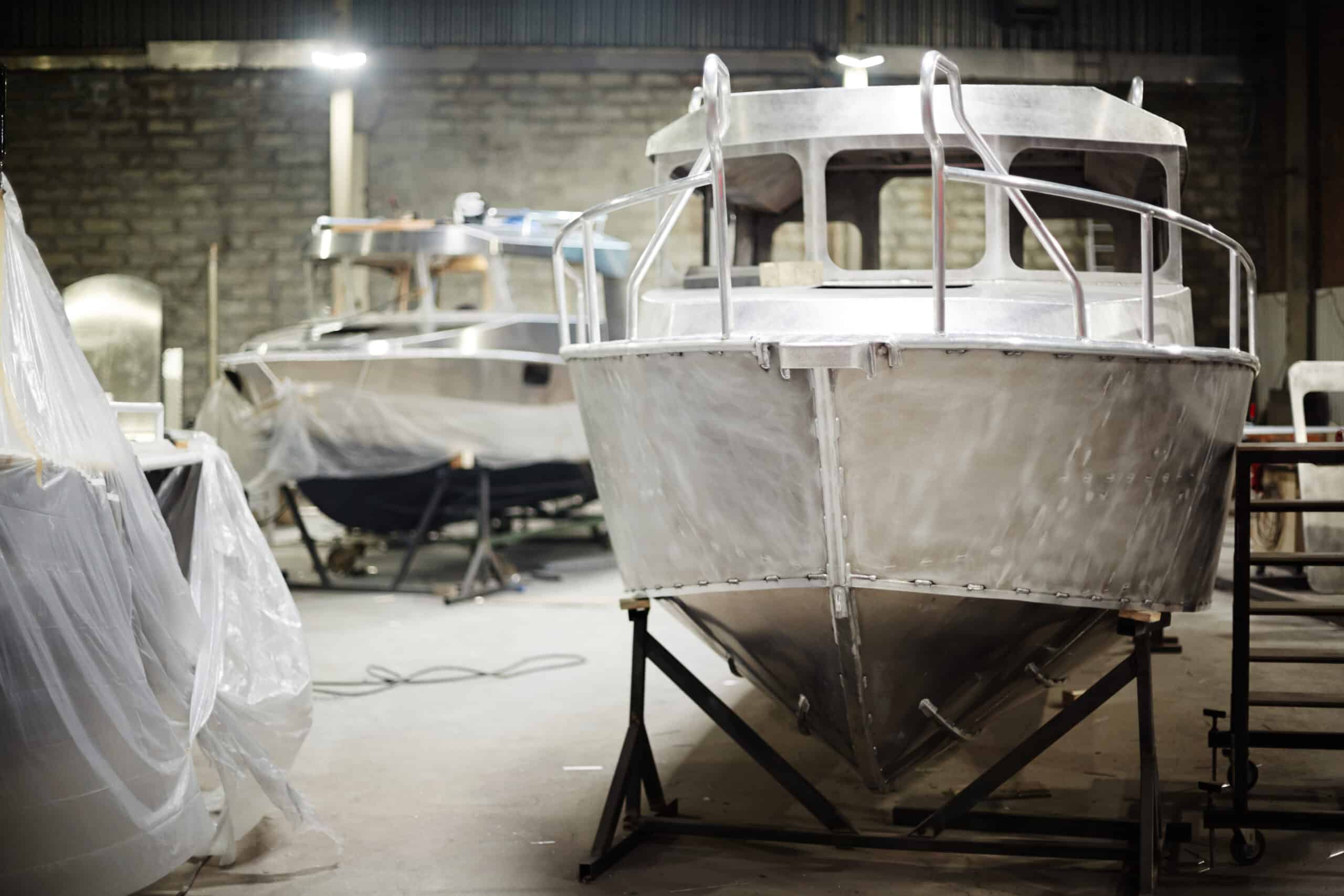 New metallic boats in contemporary boat-production department of factory