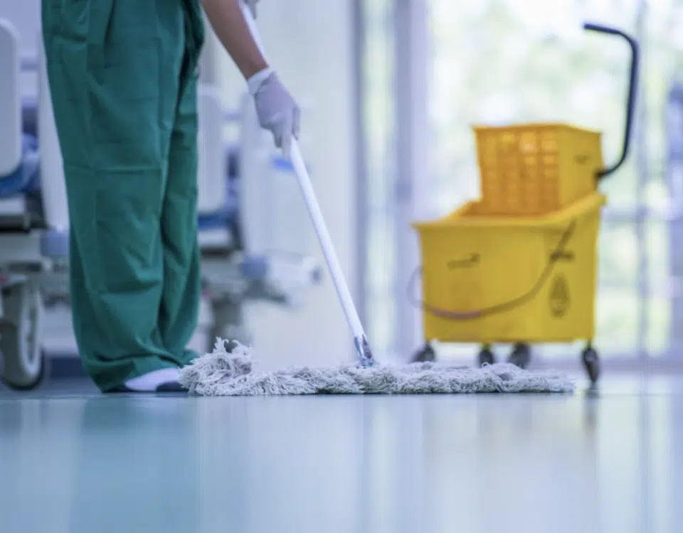 custodian cleaning epoxy floor in hospital